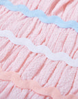 Dress for girl crafted in seersucker with a smocked bodice