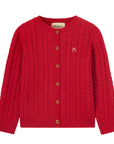 Red cable knit cardigan with gold buttons on a white background