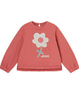 Red sweatshirt with a white flower graphic on a white background