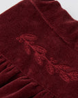 Burgundy velvet skirt with decorative elements
