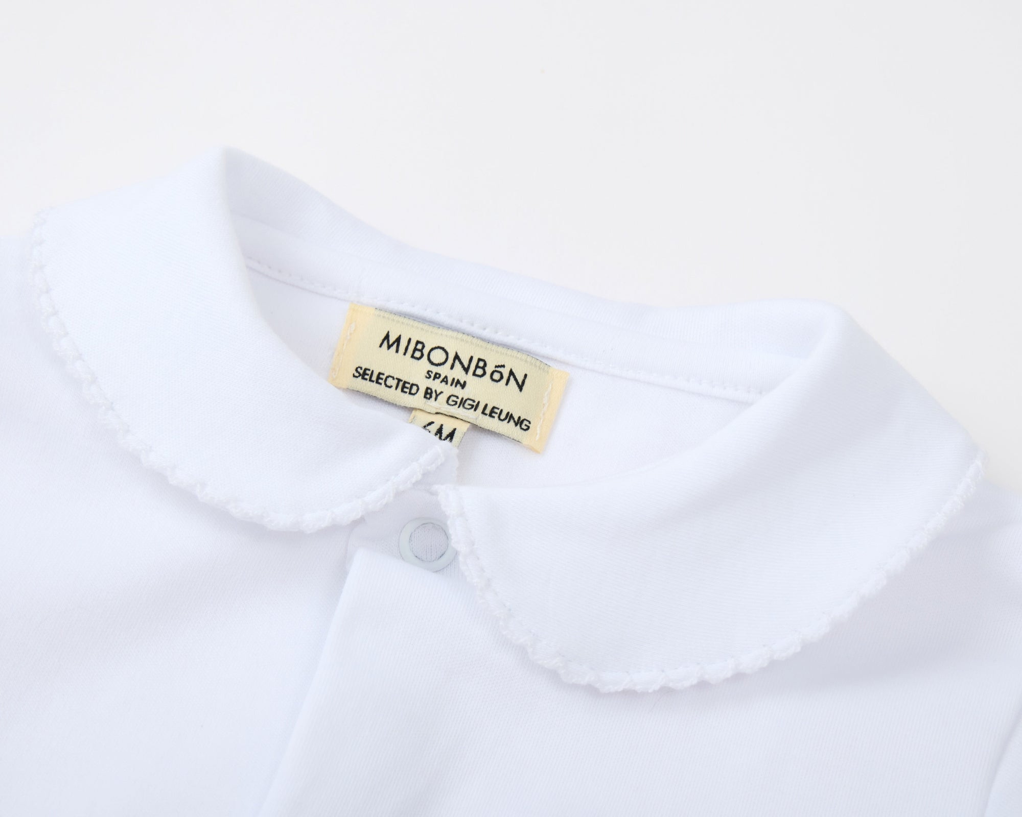 White shirt with a visible brand label on a white background