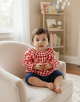 Asian baby girl in red gingham blouse with blue bloomers