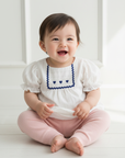 Asian baby girl in white embroidered blouse lifestyle photo