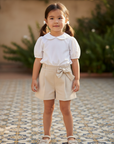 Asian girl in shorts with white blouse on Spanish tiles
