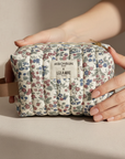 Floral toiletry bag in hands lifestyle photo
