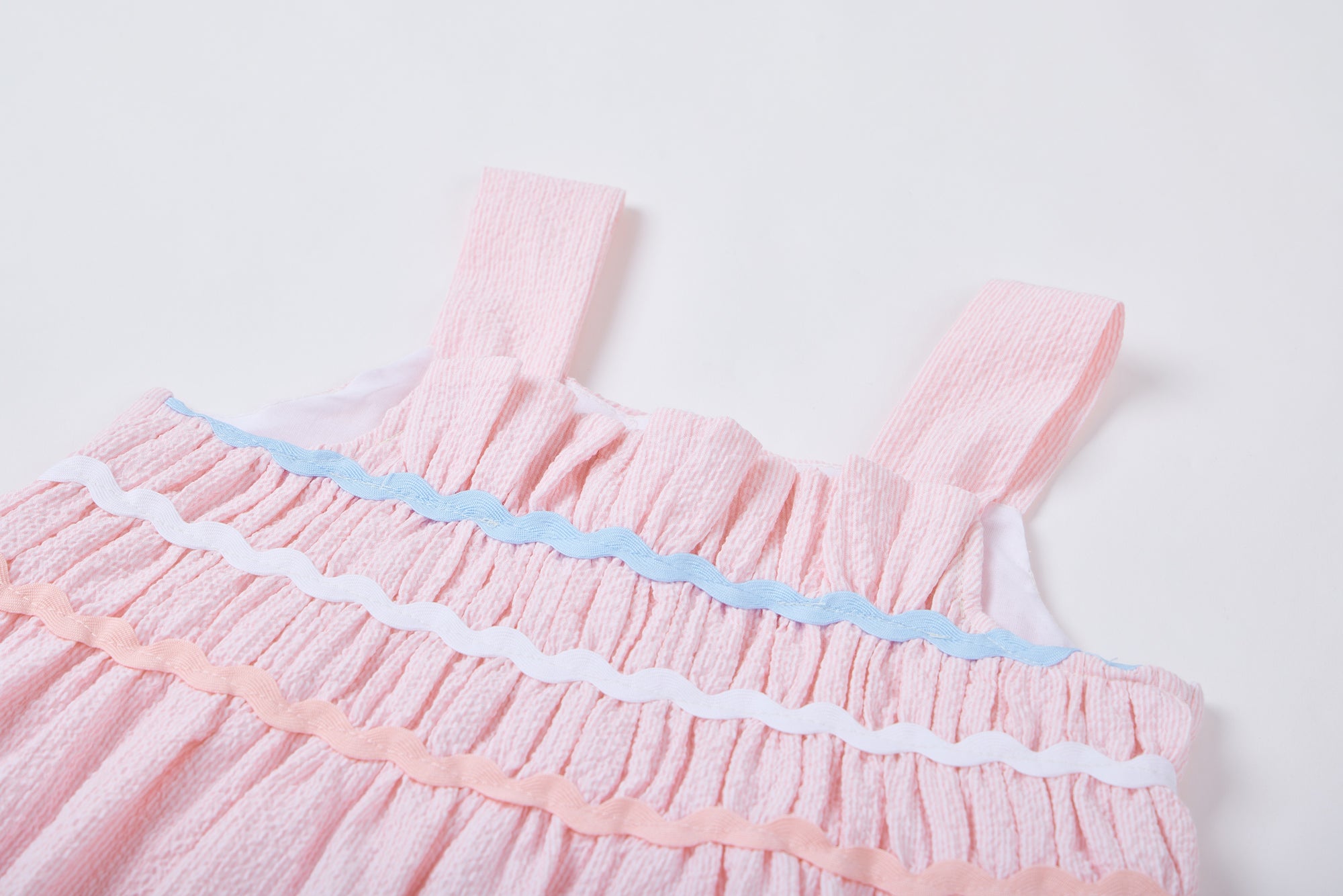 Dress for girl crafted in seersucker with a smocked bodice