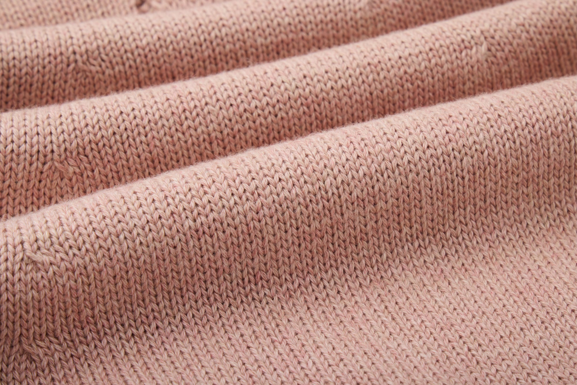 Pink knitted dress with a fluffy pink pom-pom.