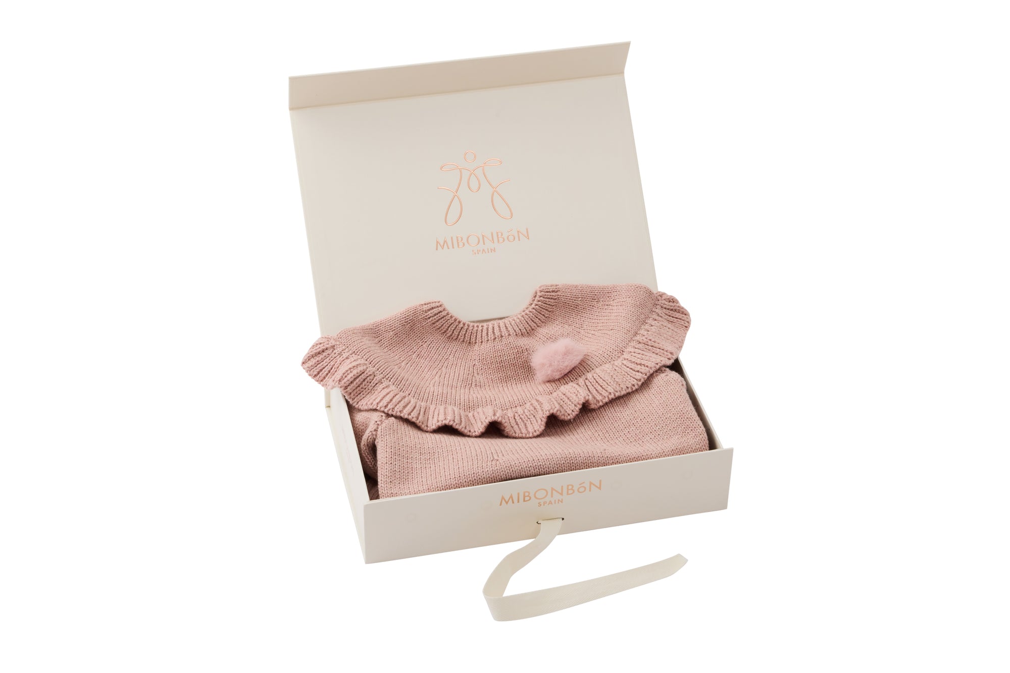 Pink knitted dress with a fluffy pink pom-pom.