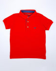 Red polo with blue contrast.