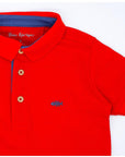 Red polo with blue contrast.