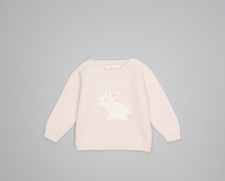 A light pink knit sweater for toddlers, featuring a white rabbit motif on the chest, displayed flat against a neutral gray background.