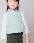 Reversible quilted vest in pink and green with ruffle.