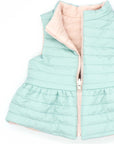 Reversible quilted vest in pink and green with ruffle.