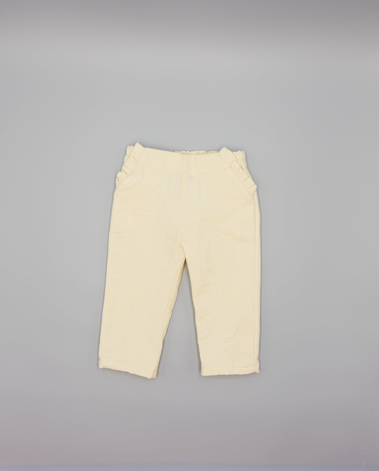 BEIGE TEXTURED TROUSERS WITH RUFFLES