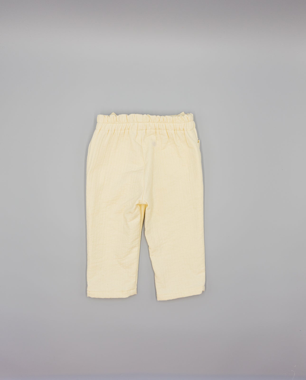 BEIGE TEXTURED TROUSERS WITH RUFFLES