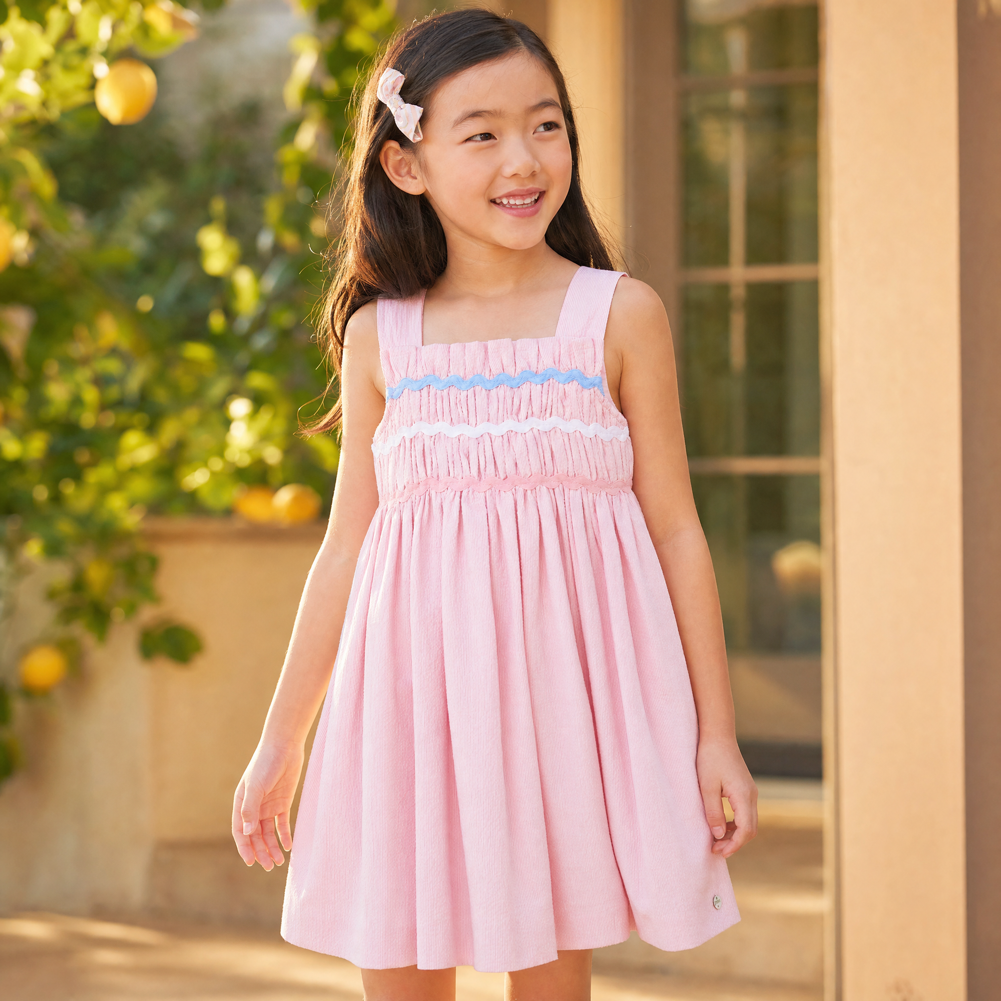 Dress for girl crafted in seersucker with a smocked bodice