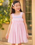 Dress for girl crafted in seersucker with a smocked bodice