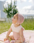 Knitted baby bodysuit with plumeti tulle overlay