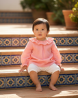 Asian Baby Girl in Pink Blouse on Spanish Patio