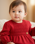 Red dress with smocked bodice and flower detail