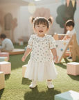 Asian baby girl standing in floral blouse outdoor