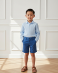 Asian Boy Blue Shirt and Shorts Indoor Lifestyle