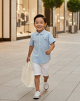 Asian boy in blue polo holding MIBONBóN bag in city