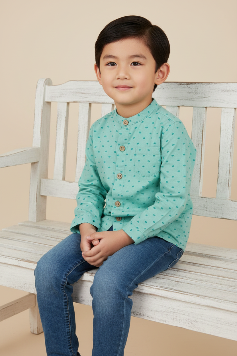 Asian boy in mint green shirt with blue jeans
