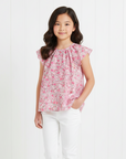 Asian girl in pink floral blouse with white pants
