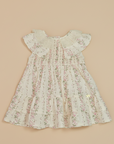 Cream floral baby dress on beige background