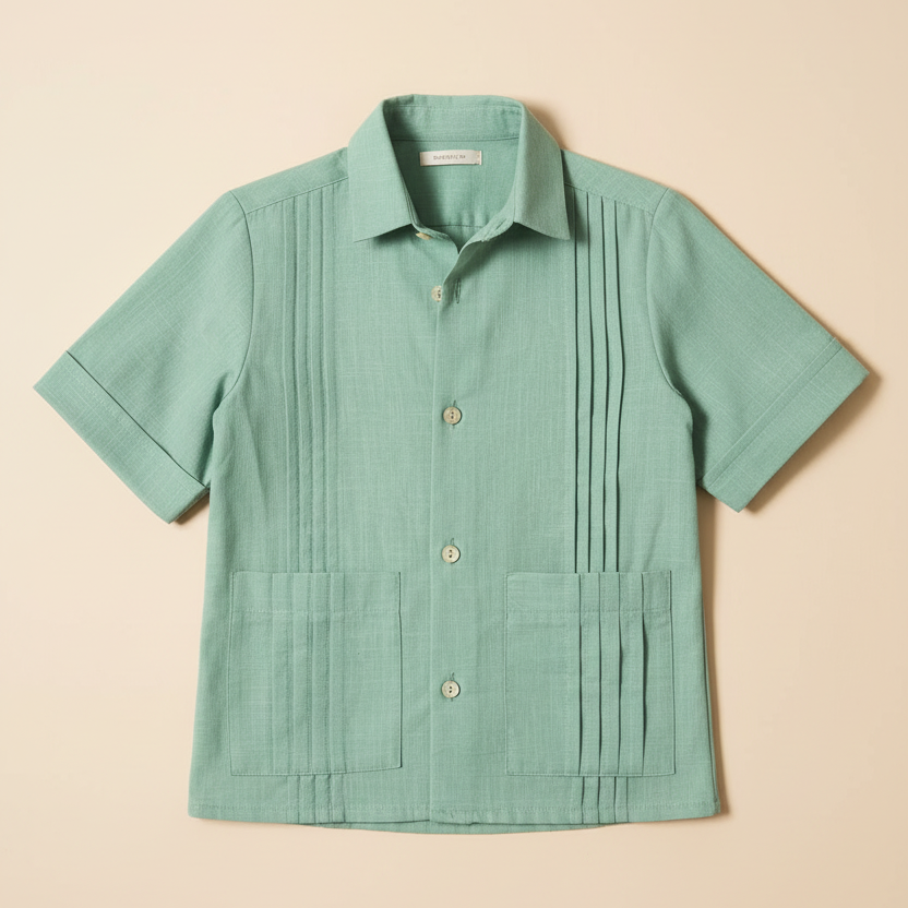 Flat lay product photo of sage green guayabera shirt on beige background