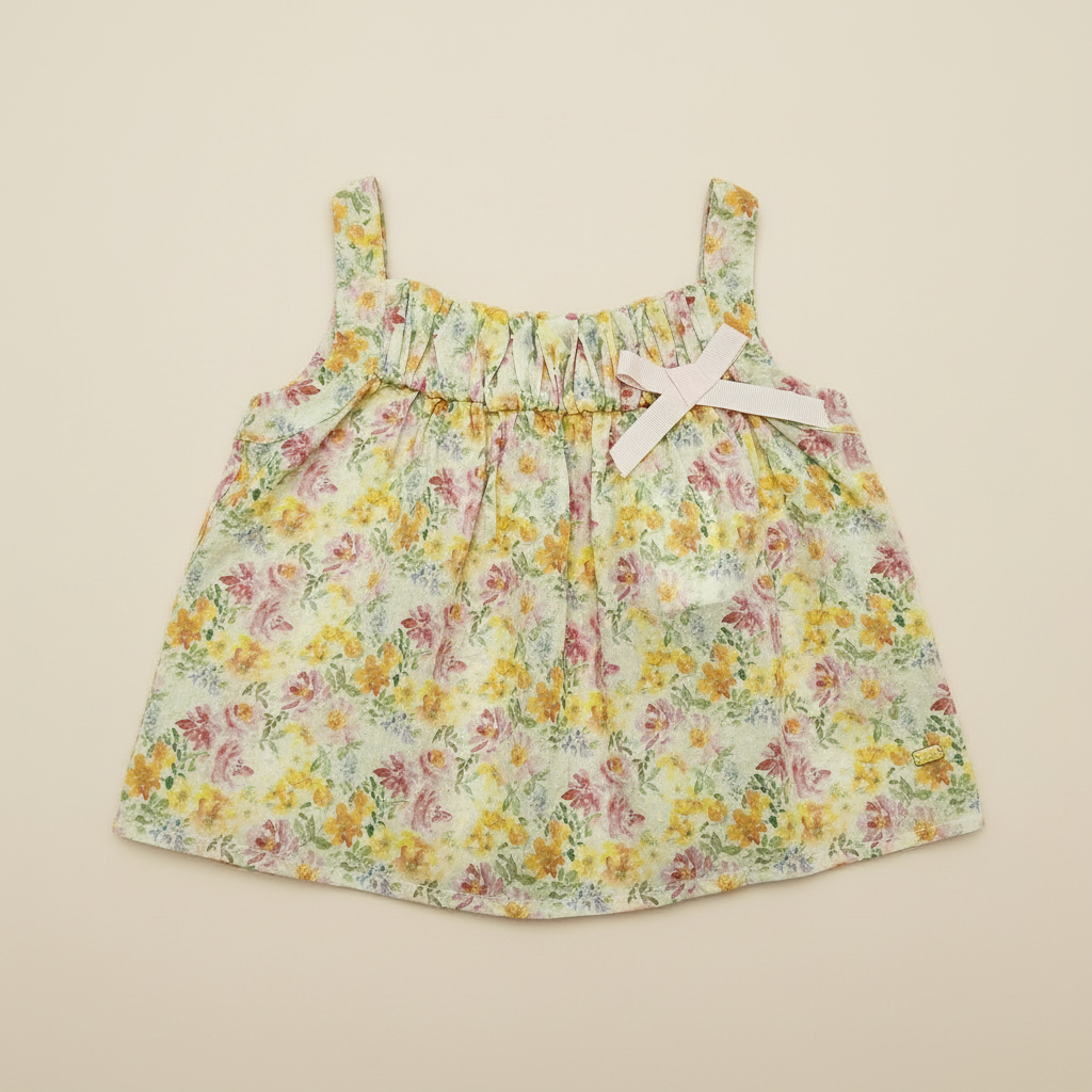 Floral baby top on beige background