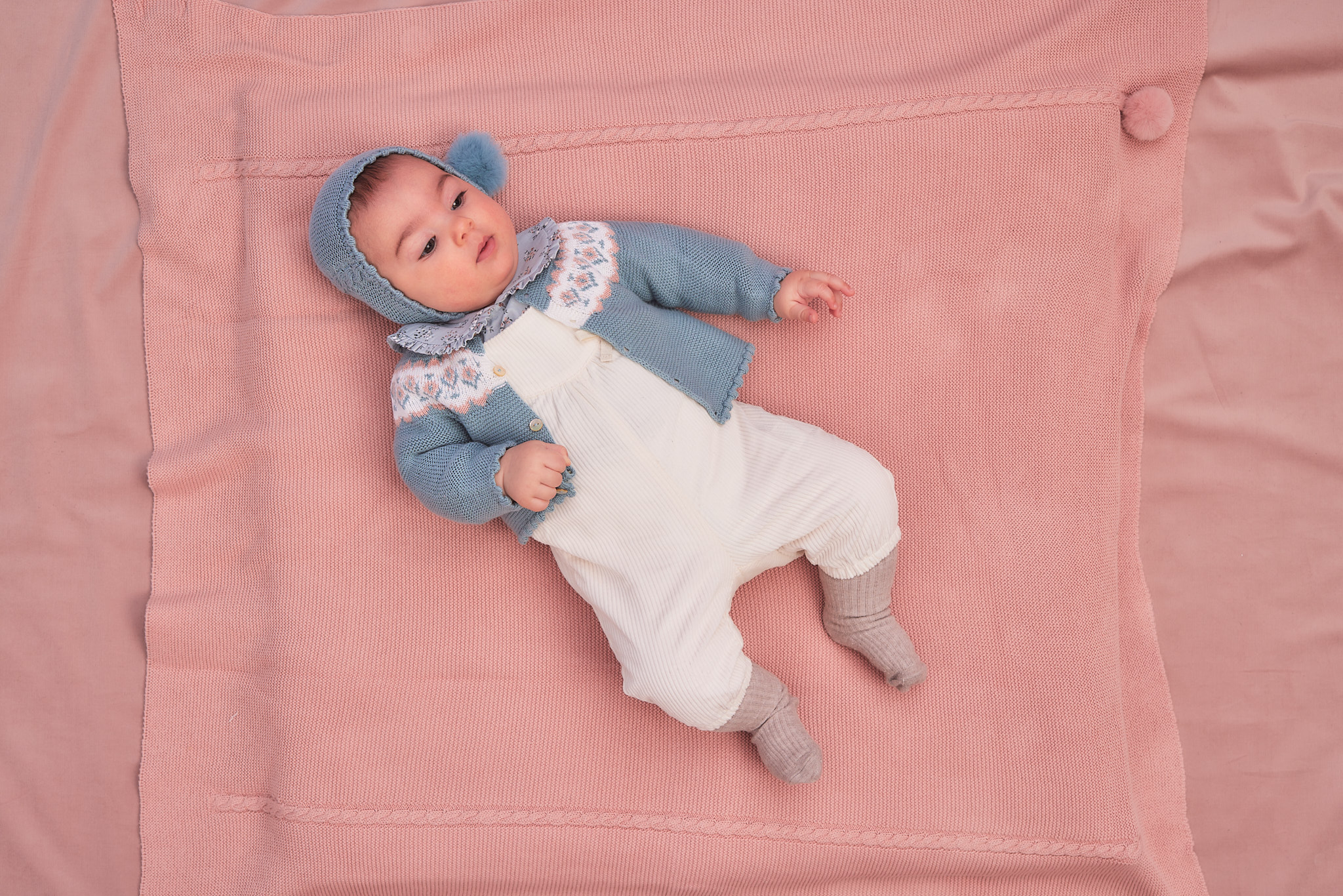 FINA baby dress in baby clothes on pink blanket