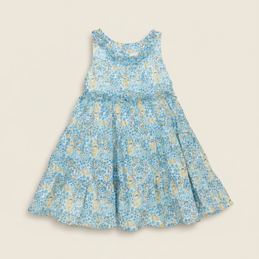 Product photo of blue floral dress on beige background